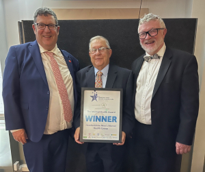 Paul Chris and Euan in suits and ties proudly hold the award received for work with men's mental health