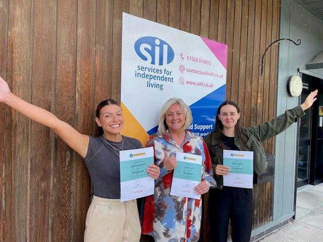 SIL staff with certificates of achievement