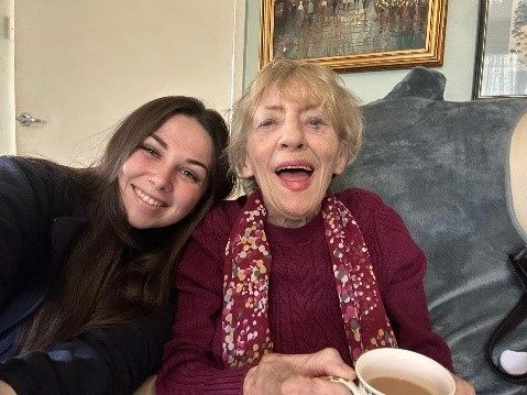 Happy image of older and young women enjoying a cup of tea together