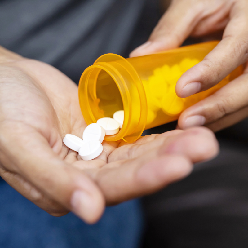 pills being tipped into the palm of a hand